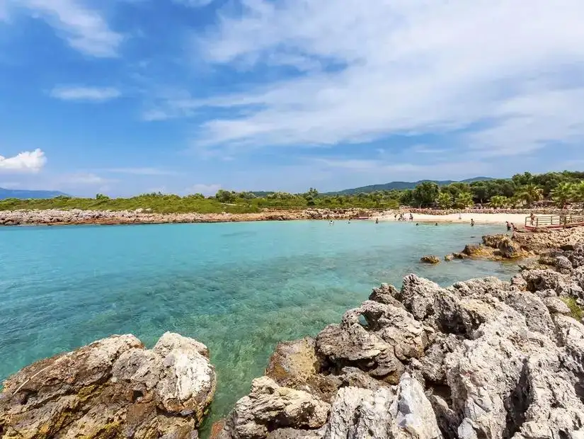 A picturesque beach at Sedir Island, known for its clear turquoise water and golden sands.