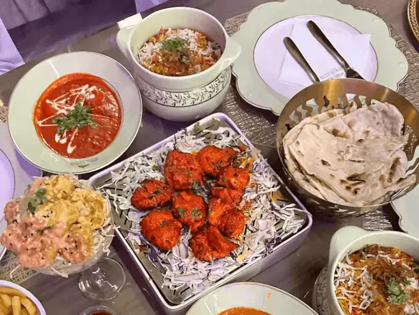 A rich and savory meal with rice, meat, and a variety of flavorful sides.