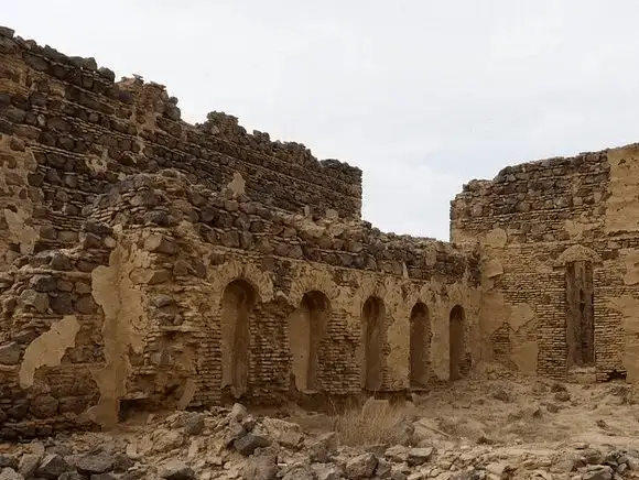 The remains of this ancient castle tell stories of a bygone era, set against a stark desert backdrop.