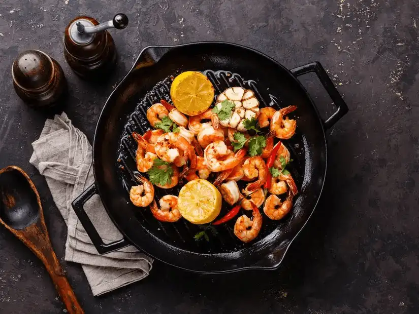 Sizzling shrimp and crab sautéed with garlic and lemon, served in a cast iron skillet.