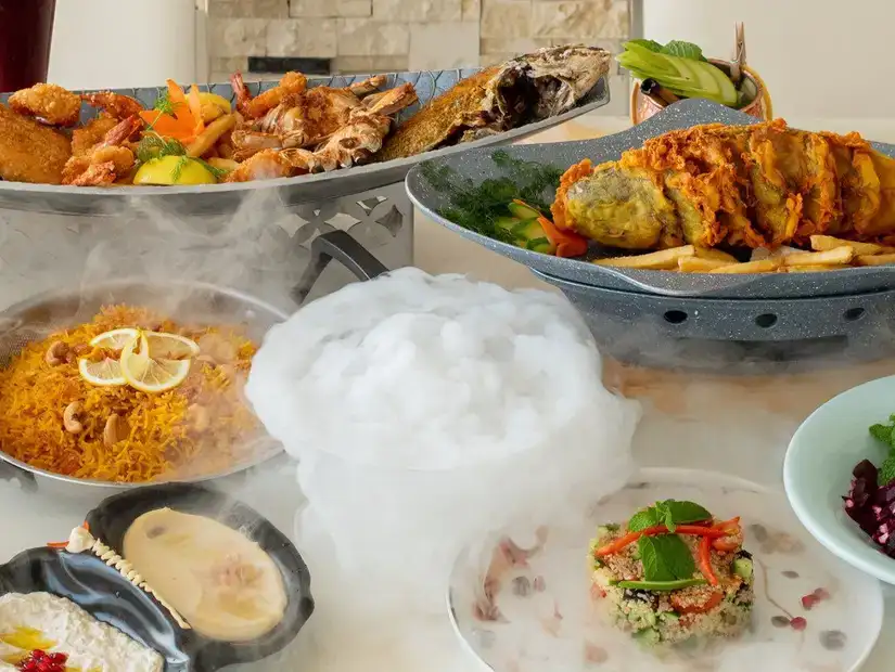 An extravagant seafood feast with multiple dishes and aromatic smoke for added drama.