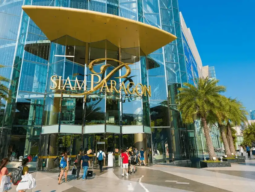 The grand entrance of Siam Paragon Mall, bustling with visitors.