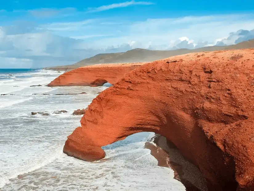 Stunning red rock arches along the coastline of Sidi Ifni.