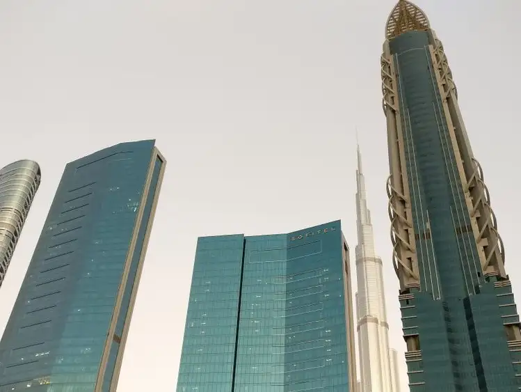 A collection of architectural marvels, including the Sofitel Dubai Downtown, with the Burj Khalifa standing tall in the background.