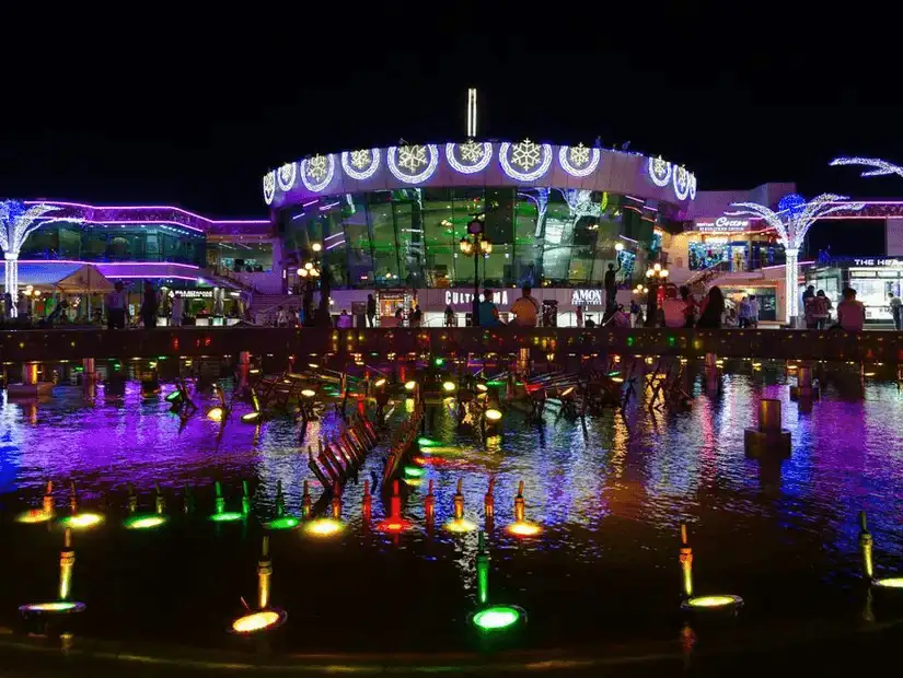 Soho Square at night, illuminated with vibrant lights, offering a lively blend of entertainment, dining, and shopping experiences.