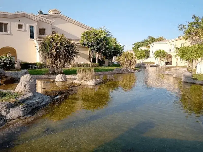 Tranquil villa surrounded by a serene water feature at Sunset Beach Resort.