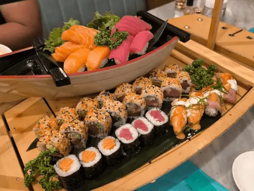 A sushi platter with assorted rolls and sashimi.