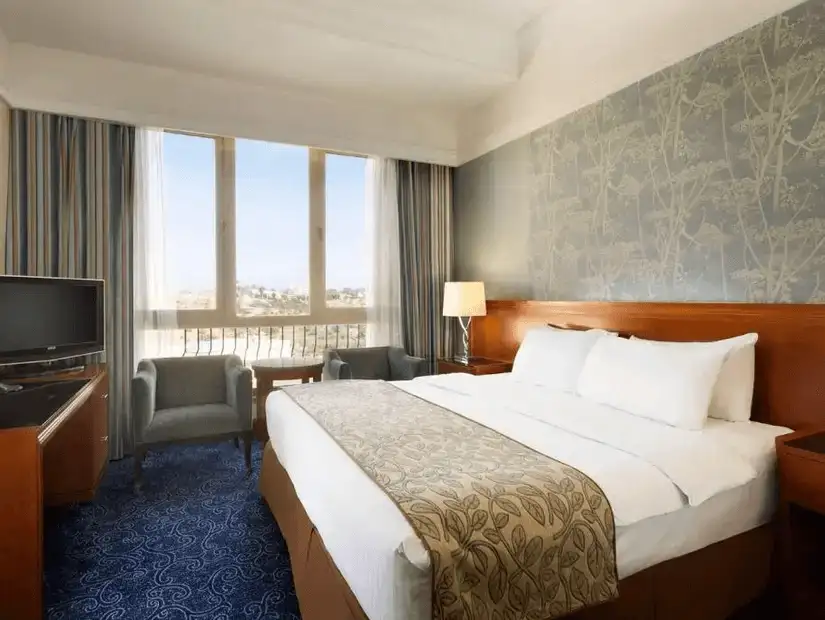 : A bright and spacious hotel room with a stunning view.