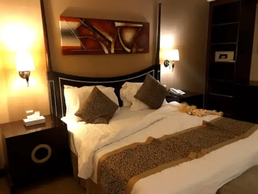 A warm and inviting hotel room with a comfortable bed and soft lighting.