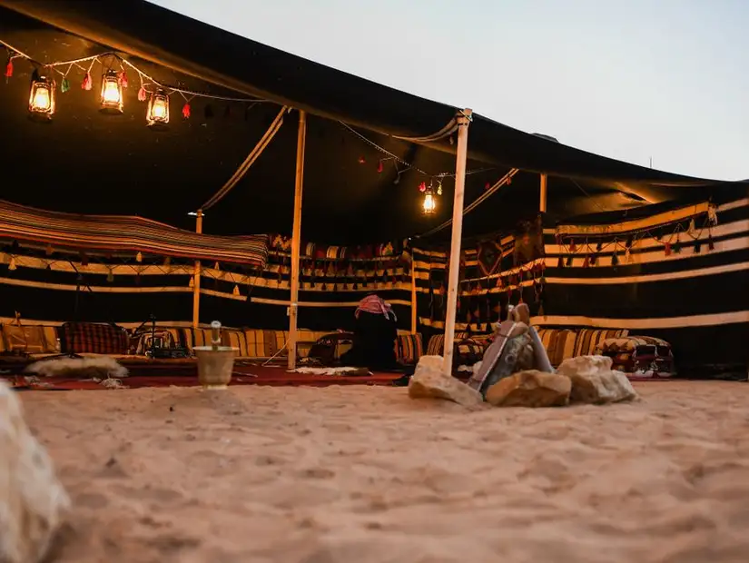 ozy Bedouin tent set against the evening desert ambiance