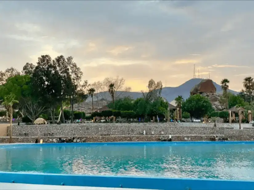 A refreshing water park with scenic mountain views in the background.