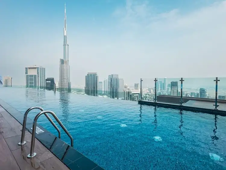 A peaceful poolside view at Taj Jumeirah Lakes Towers, with skyscrapers creating a breathtaking backdrop.