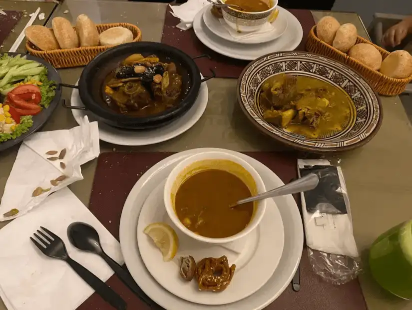 A traditional dish with rich curry, rice, and tender meat served with fresh bread.