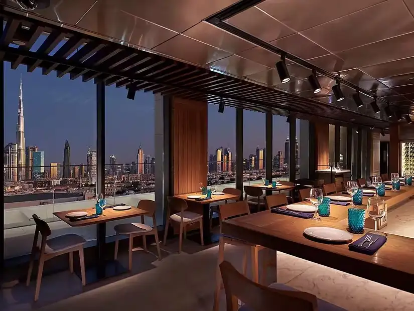 Dine above the city with a stunning view that stretches from skyscrapers to sunsets, blending elegance and serenity.