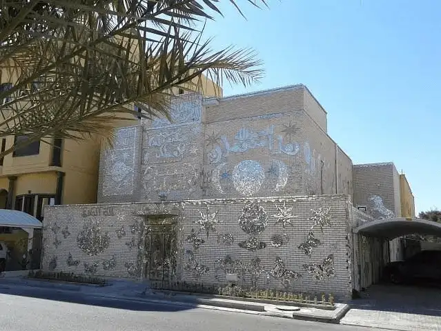 The stunning exterior of The Mirror House, a one-of-a-kind art installation in Kuwait, decorated with mirror mosaics.