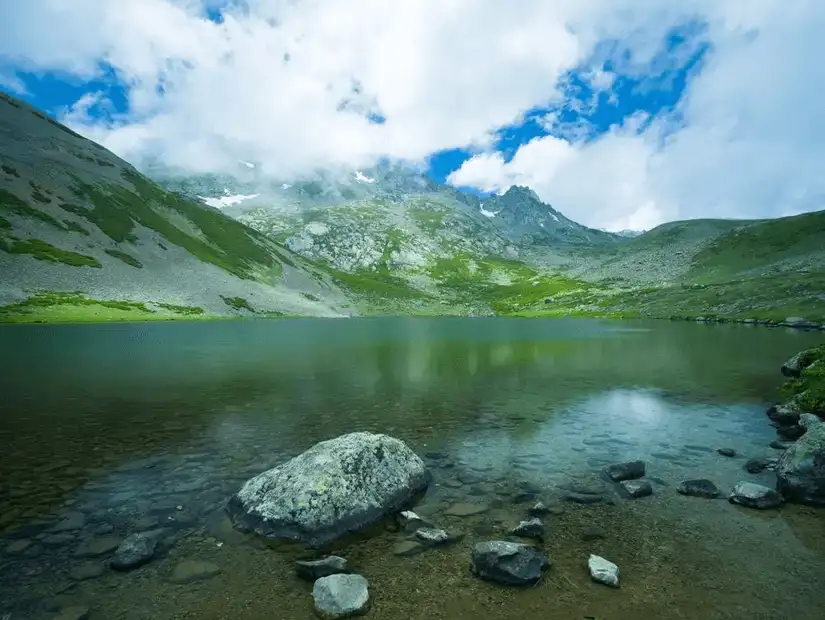 A tranquil highland lake with crystal clear water and scenic mountain views.