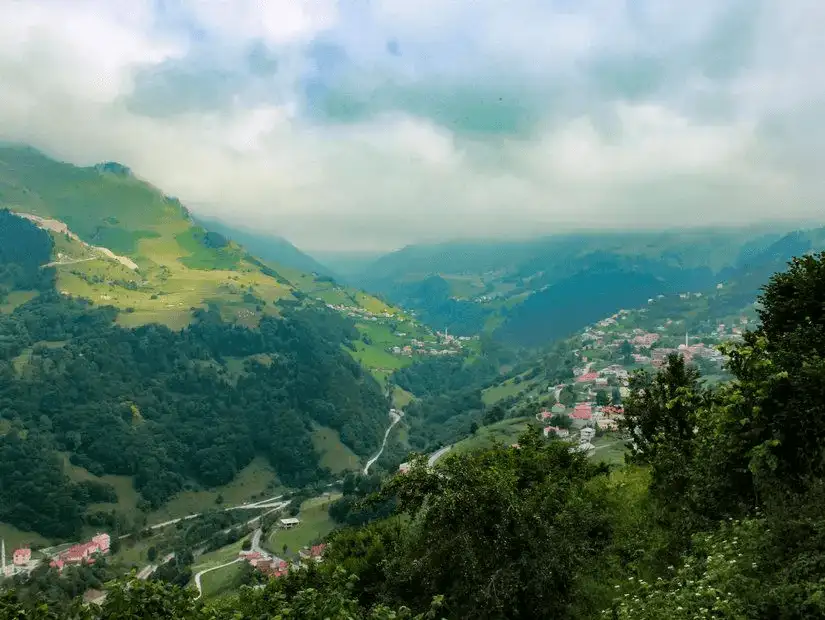 A breathtaking view of a green valley dotted with small villages.