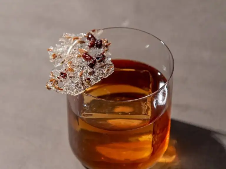A classic Old Fashioned cocktail with a twist, garnished with spiced crystallized sugar.
