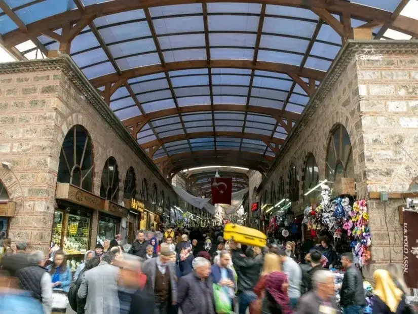 A busy scene in the historic Grand Bazaar, showcasing the vibrant atmosphere of a traditional market.