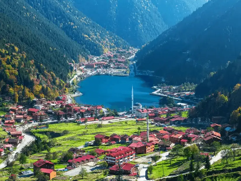 The picturesque Uzungöl Village nestled between green hills and the serene lake.