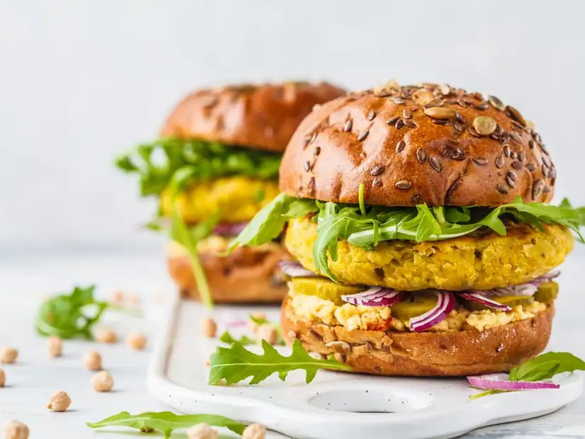 Healthy vegan burger with chickpea patty and fresh vegetables.