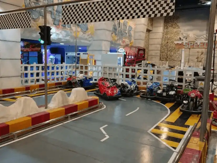 Indoor go-kart track with colorful go-karts ready to race.