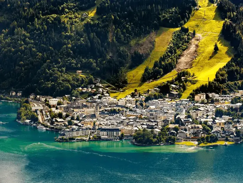 An aerial view of a charming lakeside town nestled in the mountains.